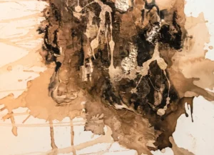 A painting of brown and black paint dripping.