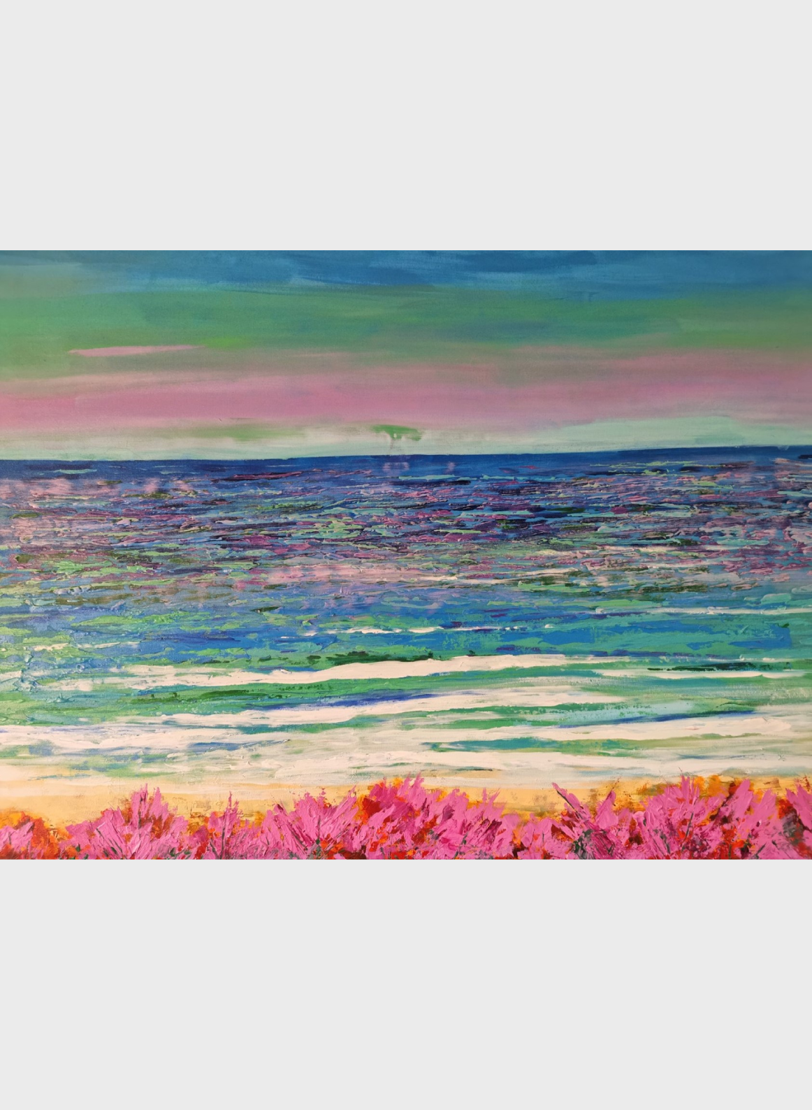A painting of the ocean and flowers in front.