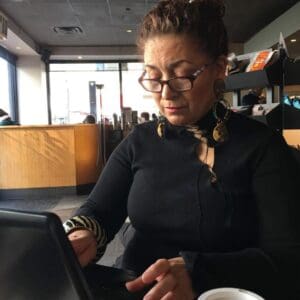 A Woman WOrking On A Laptop Screen.