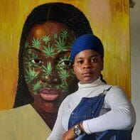 Artist posing with vibrant portrait painting.